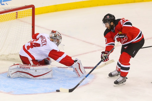 Kyle Palmieri of the New Jersey Devils and Petr Mrazek of the Detroit Red Wings