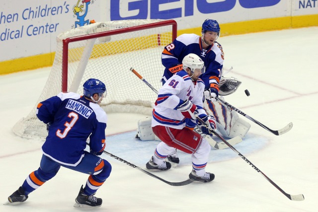 Rick Nash of the New York Rangers and Travis Hamonic of the New York Islanders