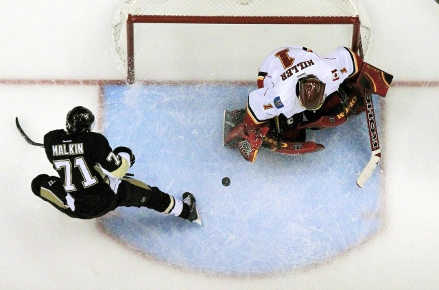 Evgeni Malkin of the Pittsburgh Penguins and Jonas Hiller of the Calgary Flames