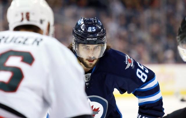 Mathieu Perreault of the Winnipeg Jets and Marcus Kruger of the Chicago Blackhawks