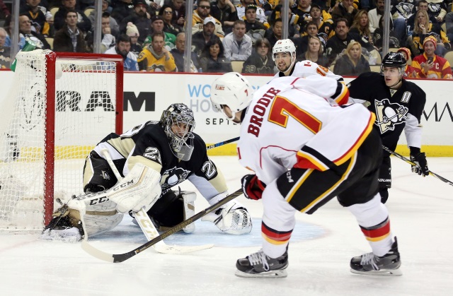 Marc-Andre Fleury of the Pittsburgh Penguins and T.J. Brodie of the Calgary Flames