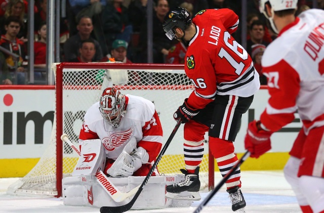 Andrew Ladd of the Chicago Blackhawks and Petr Mrazek of the Detroit Red Wings