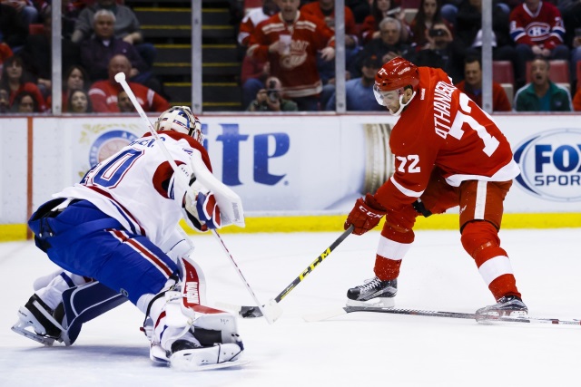 Andreas Athanasiou of the Detroit Red Wings and Ben Scrivens of the Montreal Canadiens