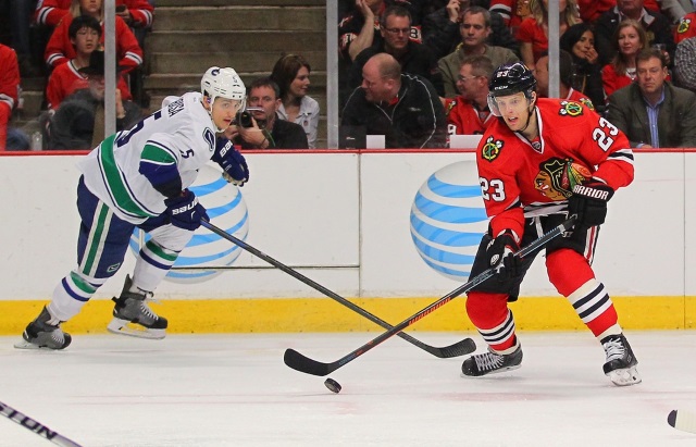 Luca Sbisa of the Vancouver Canucks and Kris Versteeg of the Chicago Blackhawks