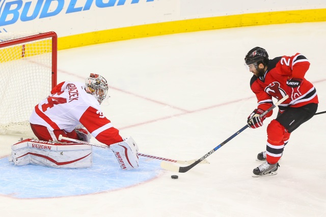 Kyle Palmieri of the New Jersey Devils and Petr Mrazek of the Detroit Red Wings