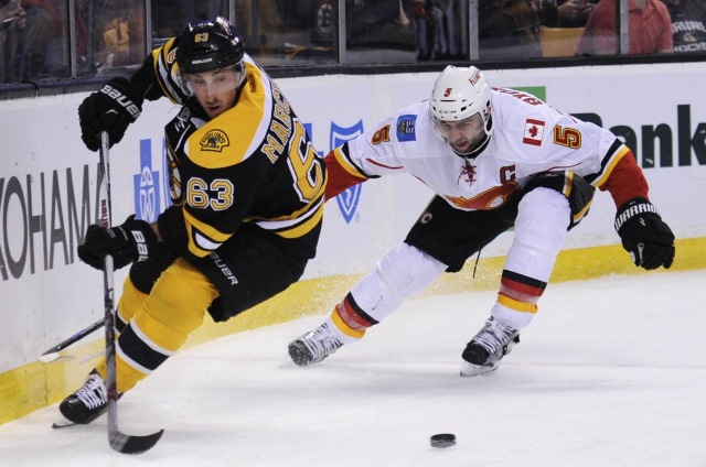 Brad Marchand of the Boston Bruins and Mark Giordano of the Calgary Flames