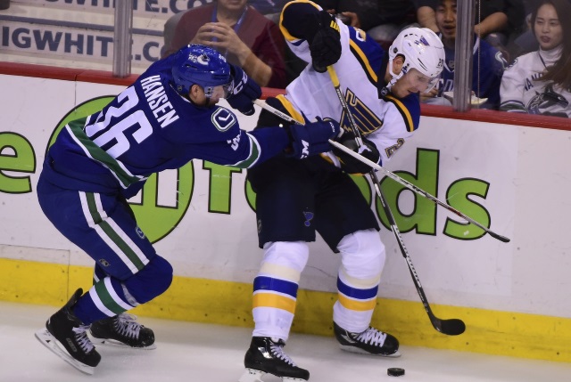 Kevin Shattenkirk of the St. Louis Blues and Jannik Hansen of the Vancouver Canucks