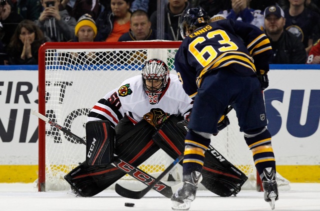 Corey Crawford of the Chicago Blackhawks and Tyler Ennis of the Buffalo Sabres