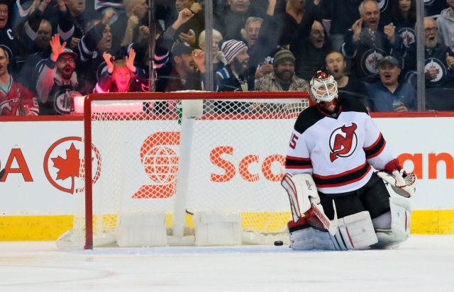 New Jersey Devils goalie Cory Schneider watches replay of Winnipeg Jets winger Patrik Laine's goal