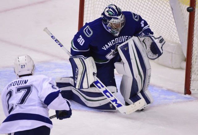 Jonathan Drouin of the Tampa Bay Lightning and Ryan Miller of the Vancouver Canucks
