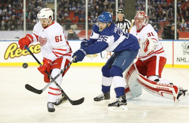 James van Riemsdyk of the Toronto Maple Leafs and Xavier Ouellet of the Detroit Red Wings