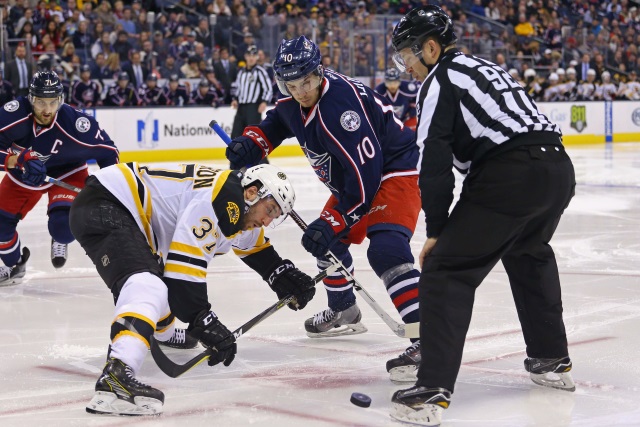 Alexander Wennberg of the Columbus Blue Jackets and Patrice Bergeron of the Boston Bruins