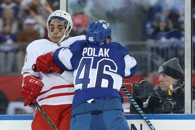 Andreas Athanasiou of the Detroit Red Wings and Roman Polak of the Toronto Maple Leafs