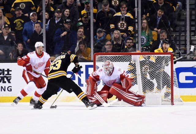 Jimmy Howard of the Detroit Red Wings and Brad Marchand of the Boston Bruins