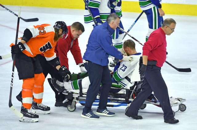 Vancouver Canucks Alex Edler gets stretchered off after hitting his face on the ice.