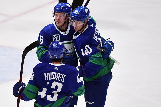 Vancouver Canucks Brock Boeser, Elias Pettersson and Quinn Hughes